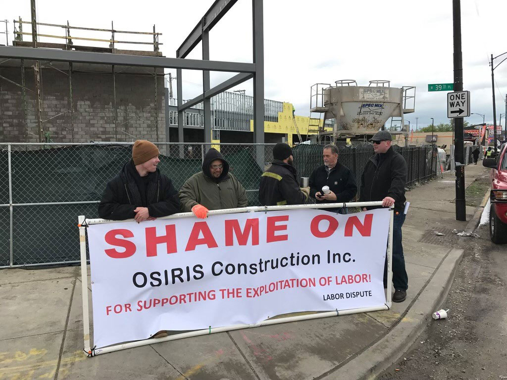 Local 54 picketers with "Shame on Osiris Construction Inc" sign