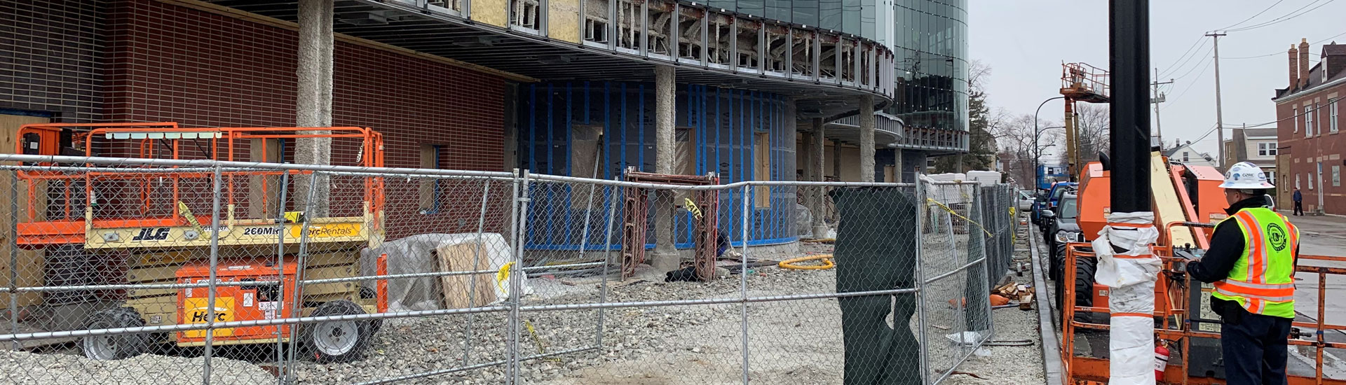 Exterior construction of highrise surrounded by fencing