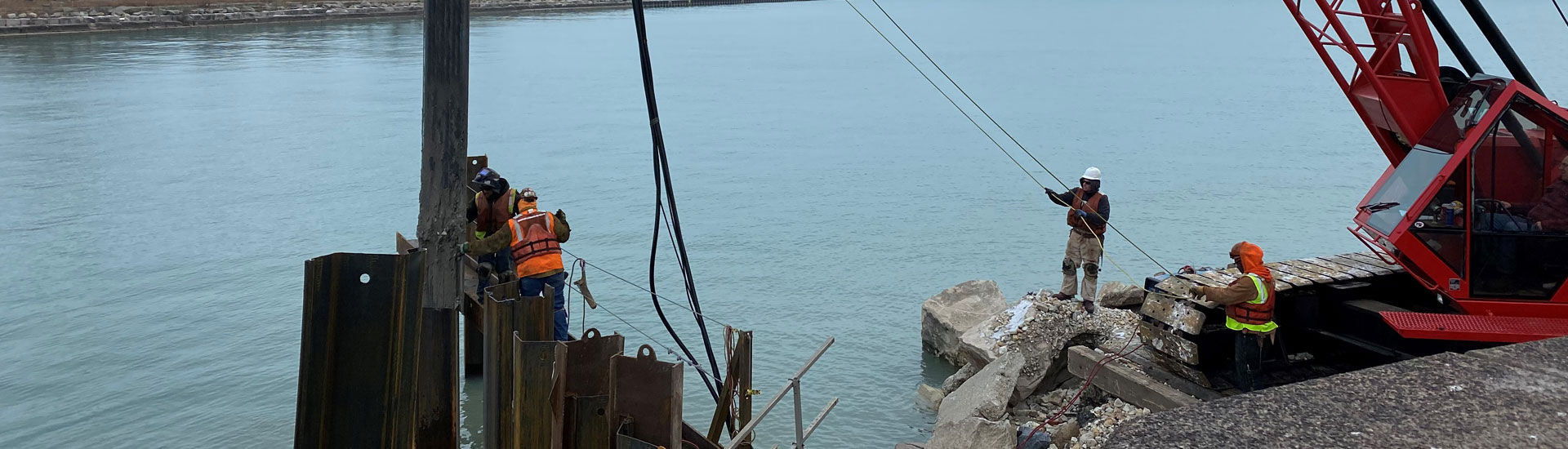 Carpenters with a crane working on Lake Michigan